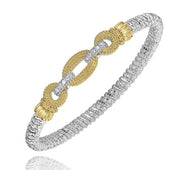 Introducing the Alwand Vahan Jewelry 4MM Closed Band (23583D04) in Size B5, a stunning silver bangle bracelet adorned with two interlocking gold loops that have textured surfaces and are enhanced with intricate silver detailing, all beautifully connected by a central silver link. The beaded design of the 4MM closed band creates a mesmerizing shimmering effect, making it an exquisite addition to any jewelry collection.