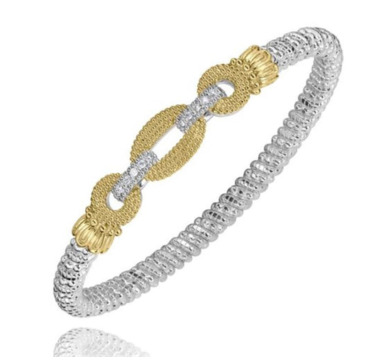 Introducing the Alwand Vahan Jewelry 4MM Closed Band (23583D04) in Size B5, a stunning silver bangle bracelet adorned with two interlocking gold loops that have textured surfaces and are enhanced with intricate silver detailing, all beautifully connected by a central silver link. The beaded design of the 4MM closed band creates a mesmerizing shimmering effect, making it an exquisite addition to any jewelry collection.