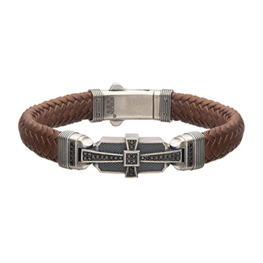 The INOX Men's Brown Leather with 925 Silver and 40 pcs Black CZ Deco Bracelet features a metal clasp and a decorative centerpiece with a geometric design, adorned with black cubic zirconia accents and silver-tone details, for a stylish and intricate look.