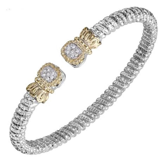 The Alwand Vahan Jewelry 4MM Band 0.07ct / Size B1 / 21645D silver bracelet features a textured design and is adorned with two gold and diamond-encrusted accents at the open ends. The intricate detailing and mix of metals offer a luxurious and elegant appearance.