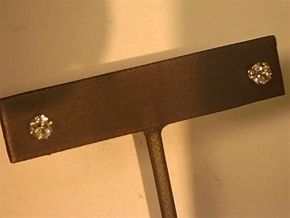 A rectangular metallic bar featuring two small 14KW 4-prong, 0.75ctw stud diamond-like stones from Veer at each end is attached to a vertical rod against a plain background.