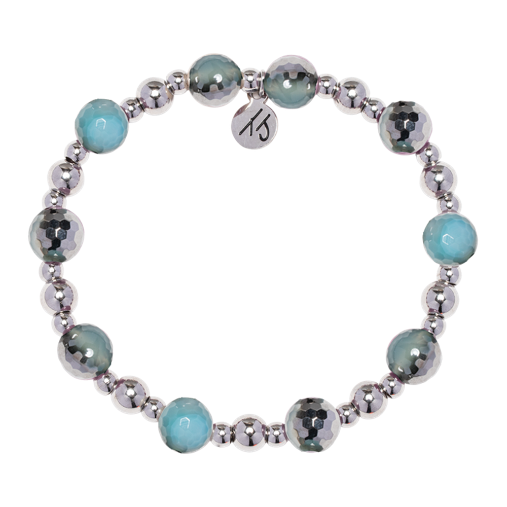 The Day by Day Collection—Blue Silver Agate Gemstone Bracelet by T Jazelle features alternating silver and teal-blue beads with a round silver charm, perfect as a gemstone or charm bracelet.