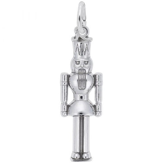 The Nutcracker Charm by Rembrandt Charms is a sterling silver piece featuring detailed craftsmanship, including a tall hat and a bearded face. The pendant has articulated arms and legs, with a small loop at the top for easy attachment to a necklace or bracelet.