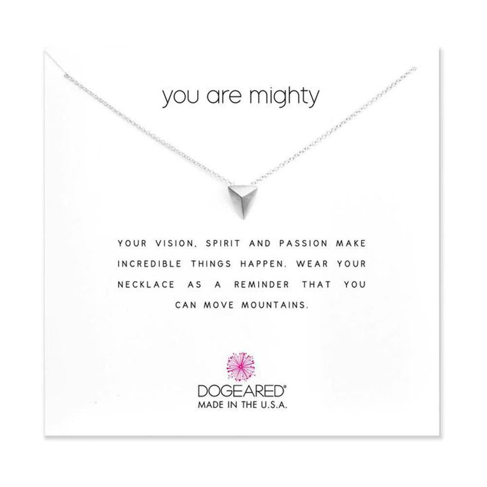 The Dogeared "You Are Mighty / SS / 18"" necklace showcases a delicate, triangular SS pendant against a white background. Behind it, a heartfelt message reads: "You Are Mighty. Your vision, spirit and passion make incredible things happen. Wear your necklace as a reminder that you can move mountains.