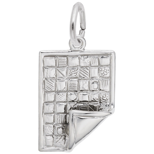 The Rembrandt Charms quilt-themed sterling silver charm features a textured book design with a quilt grid pattern. One corner curves up like a turning page, and the charm includes a small loop for attaching to bracelets or necklaces.