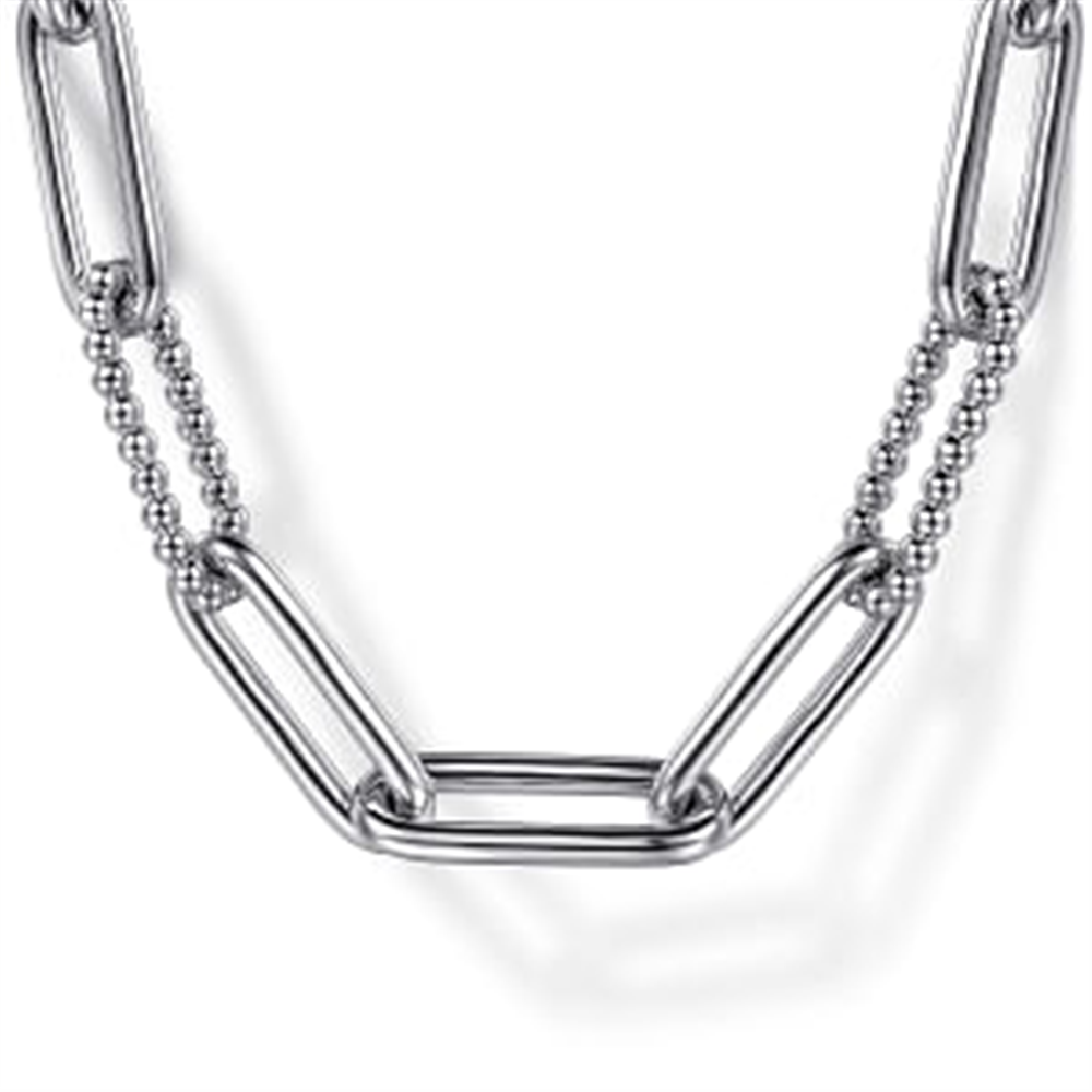 A close-up view of the Gabriel & Co 925 Sterling Silver Oval Link Chain Necklace with Bujukan Stations highlights alternating elongated oval links and smaller, round bead-like segments, all in a shiny 925 Sterling Silver finish. The design blends textures and shapes beautifully, offering a modern and stylish look against a white background.