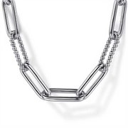 A close-up view of the Gabriel & Co 925 Sterling Silver Oval Link Chain Necklace with Bujukan Stations highlights alternating elongated oval links and smaller, round bead-like segments, all in a shiny 925 Sterling Silver finish. The design blends textures and shapes beautifully, offering a modern and stylish look against a white background.