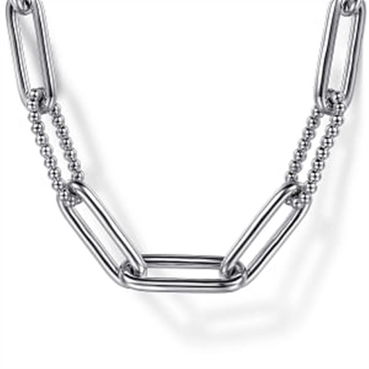 A close-up view of the Gabriel & Co 925 Sterling Silver Oval Link Chain Necklace with Bujukan Stations highlights alternating elongated oval links and smaller, round bead-like segments, all in a shiny 925 Sterling Silver finish. The design blends textures and shapes beautifully, offering a modern and stylish look against a white background.