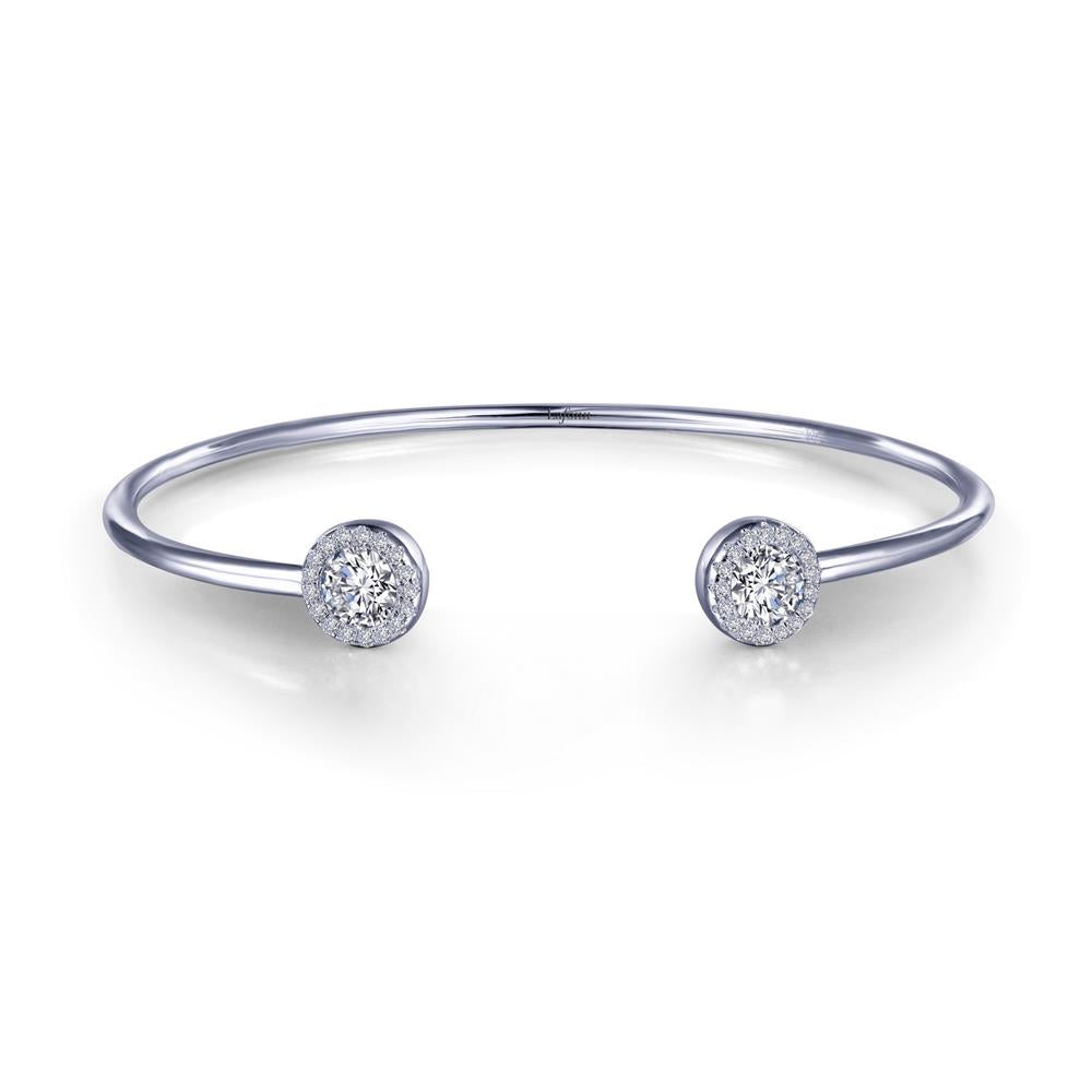 The Open Cuff Halo Bracelet by Lafonn showcases a minimalist design with a sleek, silver band and two round diamond-encrusted ends. This bracelet exudes modern elegance and luxury with its polished finish and refined appearance.