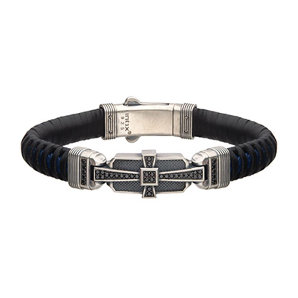 The Men's Black and Blue Leather Bracelet by INOX features a stylish silver-toned 925 Silver clasp with intricate geometric patterns. This modern bracelet is adorned with 40 black CZ accents and subtle blue highlights, surrounding a rectangular central element, enhancing its contemporary design.