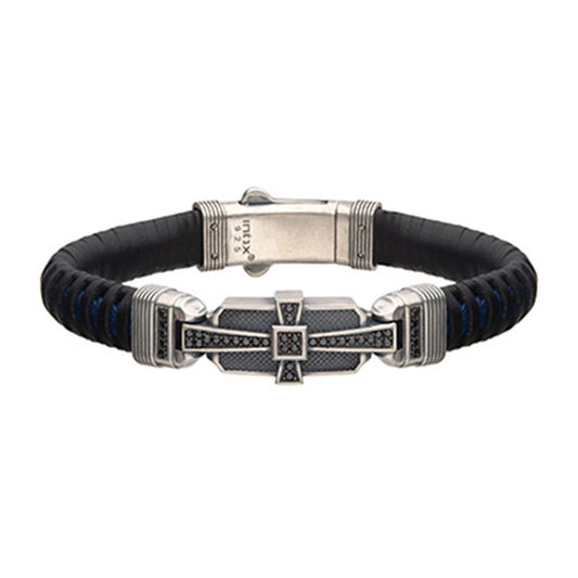 The Men's Black and Blue Leather Bracelet by INOX features a stylish silver-toned 925 Silver clasp with intricate geometric patterns. This modern bracelet is adorned with 40 black CZ accents and subtle blue highlights, surrounding a rectangular central element, enhancing its contemporary design.