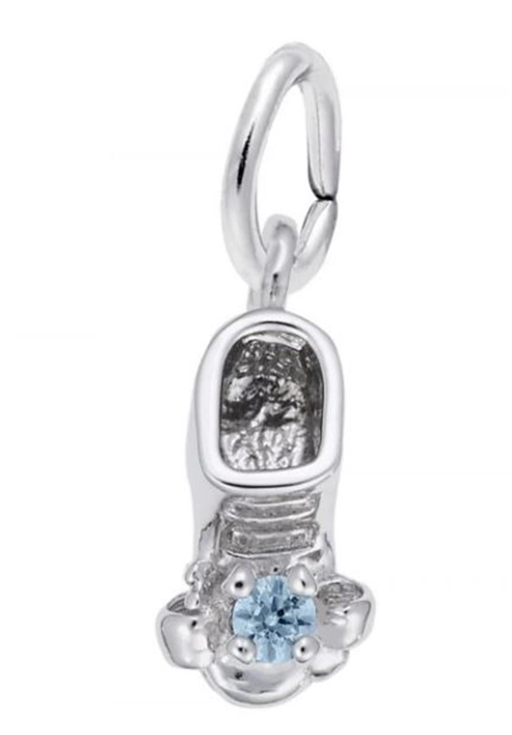 The image shows the Sterling Silver March Baby Shoe Charm from Rembrandt Charms. The charm is crafted in sterling silver and features a detailed baby shoe with an aquamarine-colored stone. It measures 0.2 inches by 0.43 inches (5 mm x 11 mm) and has the style number 2734-003. This charm is a perfect keepsake for commemorating the birth of a March baby.