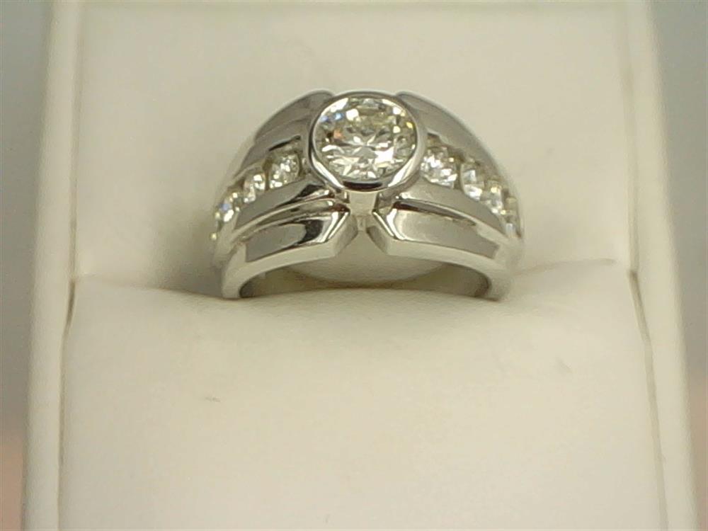 The GIA 1.00ct Diamond & 14K & 8 D ring by Diastar, LLC-Diastar, boasts a large central GIA Diamond surrounded by smaller diamonds embedded along the 14K band, all showcased on a white cushion. The ring features a split shank design leading up to the central stone.