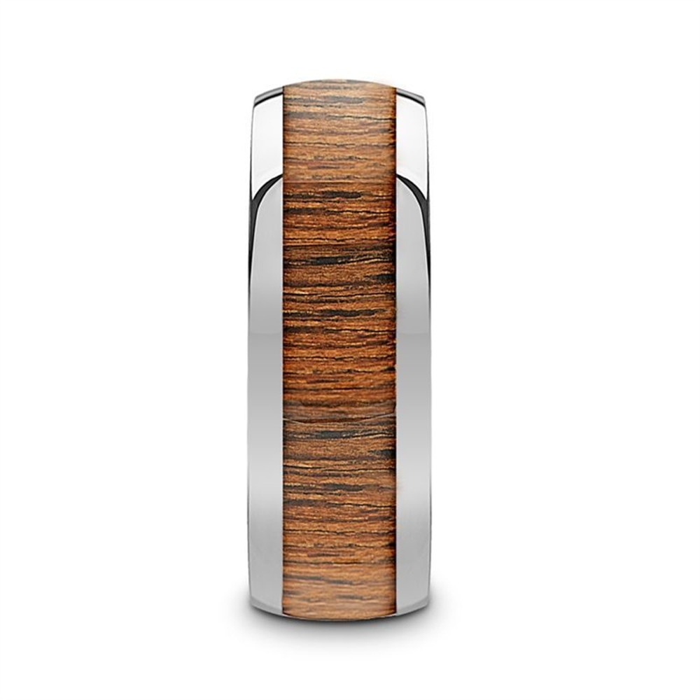 The KAMEHA Tungsten Domed Profile Polished Finish Men’s Wedding Ring by Thorsten features a polished tungsten design with a central inlay of warm brown koa wood, showcasing its natural patterns. This combination of materials provides the ring with a modern and elegant appearance.
