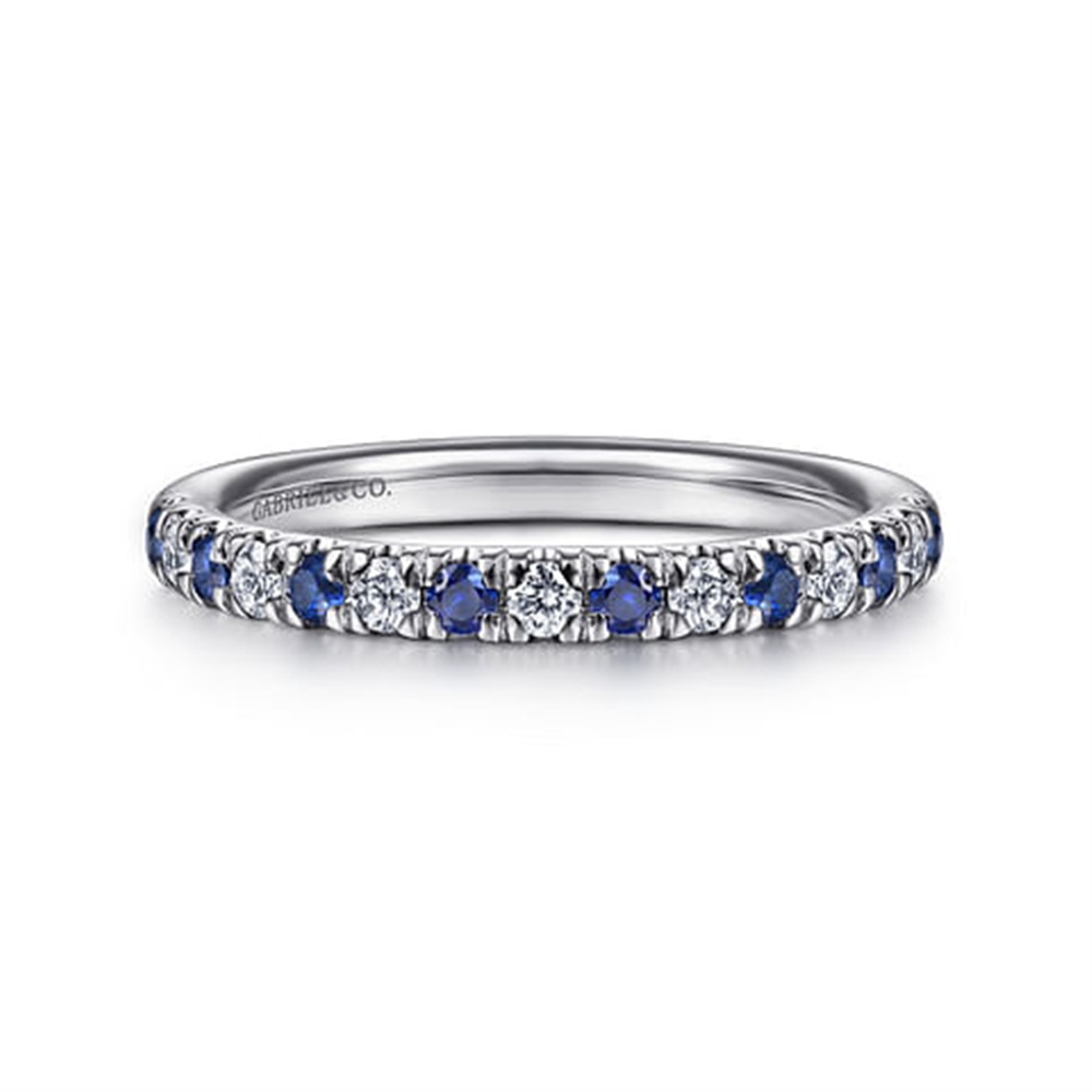 The 14K White Gold Diamond & Sapphire Anniversary Band by Gabriel & Co features alternating blue sapphires and white diamonds in a continuous loop. Stackable with other rings, it is engraved with branding on the interior and boasts a polished finish.
