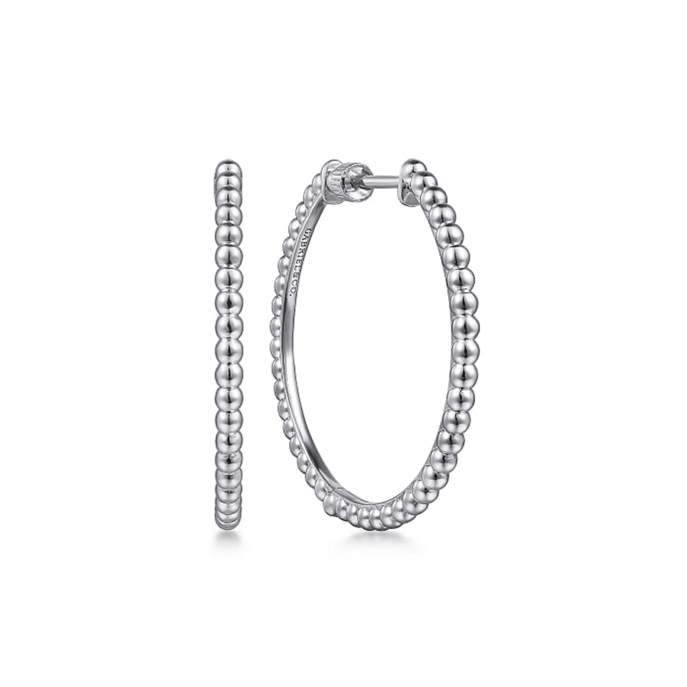 A pair of 30mm Sterling Silver Bujukan Classic Hoop Earrings from Gabriel & Co. The classic hoops feature a continuous pattern of spherical beads, creating a textured appearance. One earring is shown front-facing while the other displays its side profile against a white and minimalistic background.