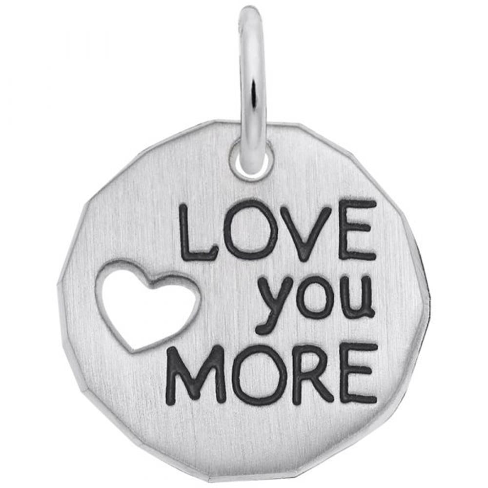 The Rembrandt Charms "Love You More" Charm is a round sterling silver pendant featuring a small heart-shaped cutout on the left side and the phrase "LOVE you MORE" engraved in bold letters on the right side. It includes a small loop at the top for easy attachment to a chain or keyring.