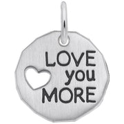 The Rembrandt Charms "Love You More" Charm is a round sterling silver pendant featuring a small heart-shaped cutout on the left side and the phrase "LOVE you MORE" engraved in bold letters on the right side. It includes a small loop at the top for easy attachment to a chain or keyring.