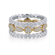 This elegant 3 Pc ring set from Lafonn features intricately designed rings stacked together. Each ring showcases alternating gold and silver settings encrusted with small diamonds, creating a luxurious and sparkling appearance that elevates any jewelry collection.