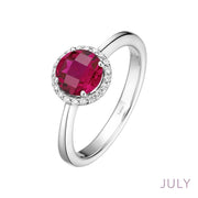 The Lafonn July Birthstone Ring is a silver ring featuring a round, red gemstone at the center, surrounded by a halo of small white diamonds. The word "JULY" is written in the bottom right corner, indicating the birthstone month for this exquisite Ruby Ring.