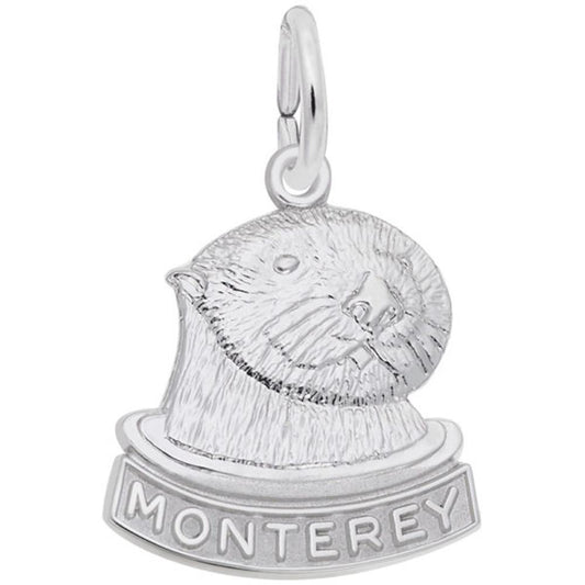 The Rembrandt Charms Monterey Sea Otter Charm in sterling silver features the head of a Monterey sea otter with "Monterey" inscribed below it, and includes a loop at the top for attaching to a bracelet or necklace.