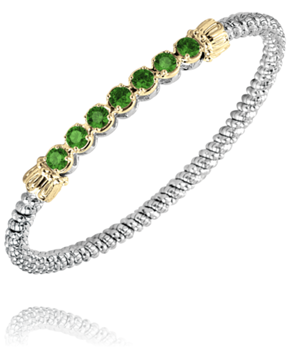 A sterling silver and 14k gold bracelet by Alwand Vahan Jewelry, highlighted with a beaded texture throughout, featuring seven round green gemstones, each set in a delicate gold setting.