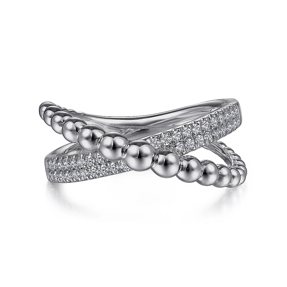 The Gabriel & Co 925 Sterling Silver Bujukan Criss Cross Ring features a unique twisted design. One band is adorned with small, polished silver beads, while the other gleams with sparkling white sapphires, enhancing its elegant and modern appearance through contrasting textures.