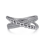 The Gabriel & Co 925 Sterling Silver Bujukan Criss Cross Ring features a unique twisted design. One band is adorned with small, polished silver beads, while the other gleams with sparkling white sapphires, enhancing its elegant and modern appearance through contrasting textures.