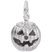 The Rembrandt Charms Jack O Lantern Charm, crafted from sterling silver, features a carved, smiling face with triangular eyes and nose, along with a wide, jagged mouth. This Halloween charm includes a loop at the top for easy attachment to a bracelet or necklace.