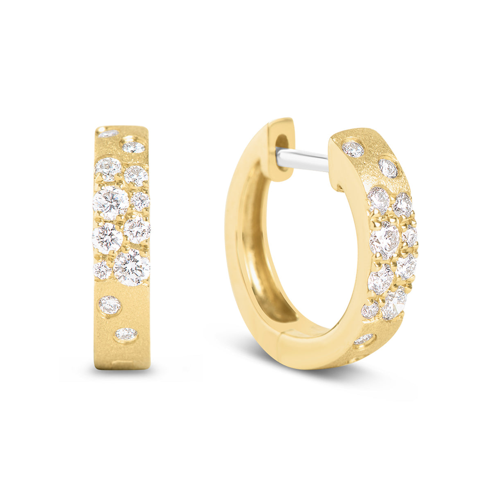 A pair of Dilamani Diamond Scatter Huggie Hoops, featuring a satin finish in 14k yellow gold and adorned with multiple round white diamonds totaling 0.32 carats, displayed on a plain white background.