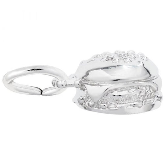 The Rembrandt Charms Hamburger Charm, made from sterling silver, is a small and shiny charm intricately designed to resemble a hamburger with detailed bun, patty, and fillings. It features a loop on top for easy attachment to a bracelet or necklace.