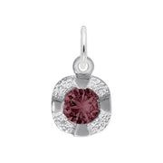 Introducing the Petite Birthstone - June Charm by Rembrandt Charms, a stunning sterling silver pendant showcasing a round, faceted maroon gemstone at its center. This elegant birthstone is encased within a gleaming silver frame adorned with delicate glittering accents. The charm features a small loop at the top for easy attachment to any chain or necklace, making it an exquisite choice for those celebrating June birthdays.