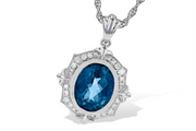The London Blue Topaz and Diamonds 14K White Gold Necklace by Allison Kaufman features a large, oval-shaped London blue topaz pendant. The gemstone is surrounded by sparkling diamonds set in an ornate 14K white gold frame with detailed decorative accents, all showcased on an intricate silver chain.