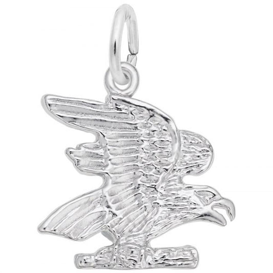 The Rembrandt Charms Eagle Charm is crafted in sterling silver and features a detailed eagle with intricately sculpted feathers, wings spread wide, and perched on a small branch. This elegant jewelry piece includes a loop at the top for easy attachment to a bracelet or necklace.