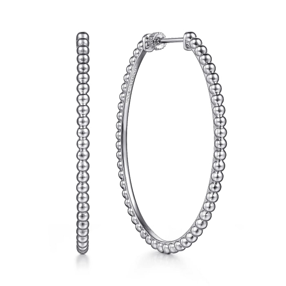 A pair of 925 Sterling Silver Bujukan Oval Classic Hoop Earrings from the Gabriel & Co Bujukan Collection is displayed against a white background. Made from high-quality 925 sterling silver, these earrings feature small, round beads arranged in a continuous loop, giving them a textured appearance. One earring is shown from the side, while the other is front-facing.