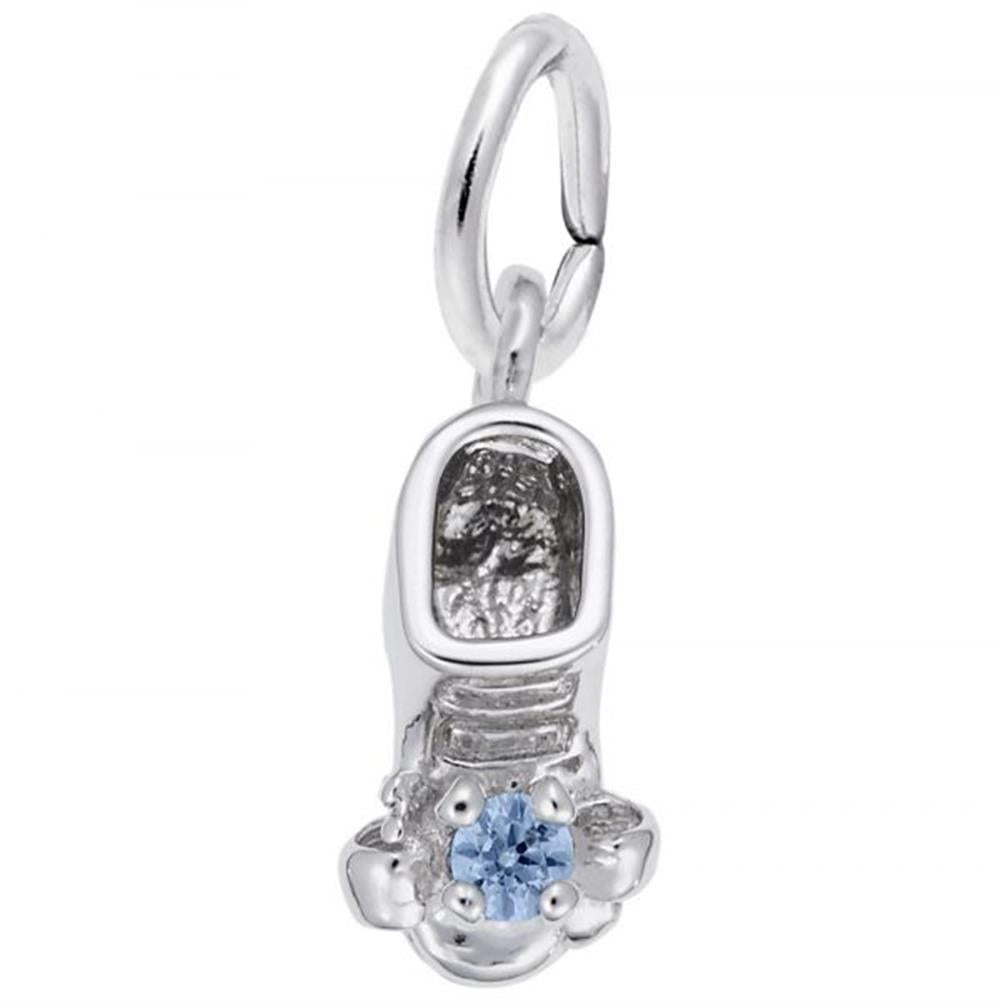 The December Baby Bootie Charm by Rembrandt Charms, crafted in sterling silver, features detailed grooves and patterns adorned with a small blue topaz gemstone at the toe. It includes an attached loop for fastening to a bracelet or necklace.