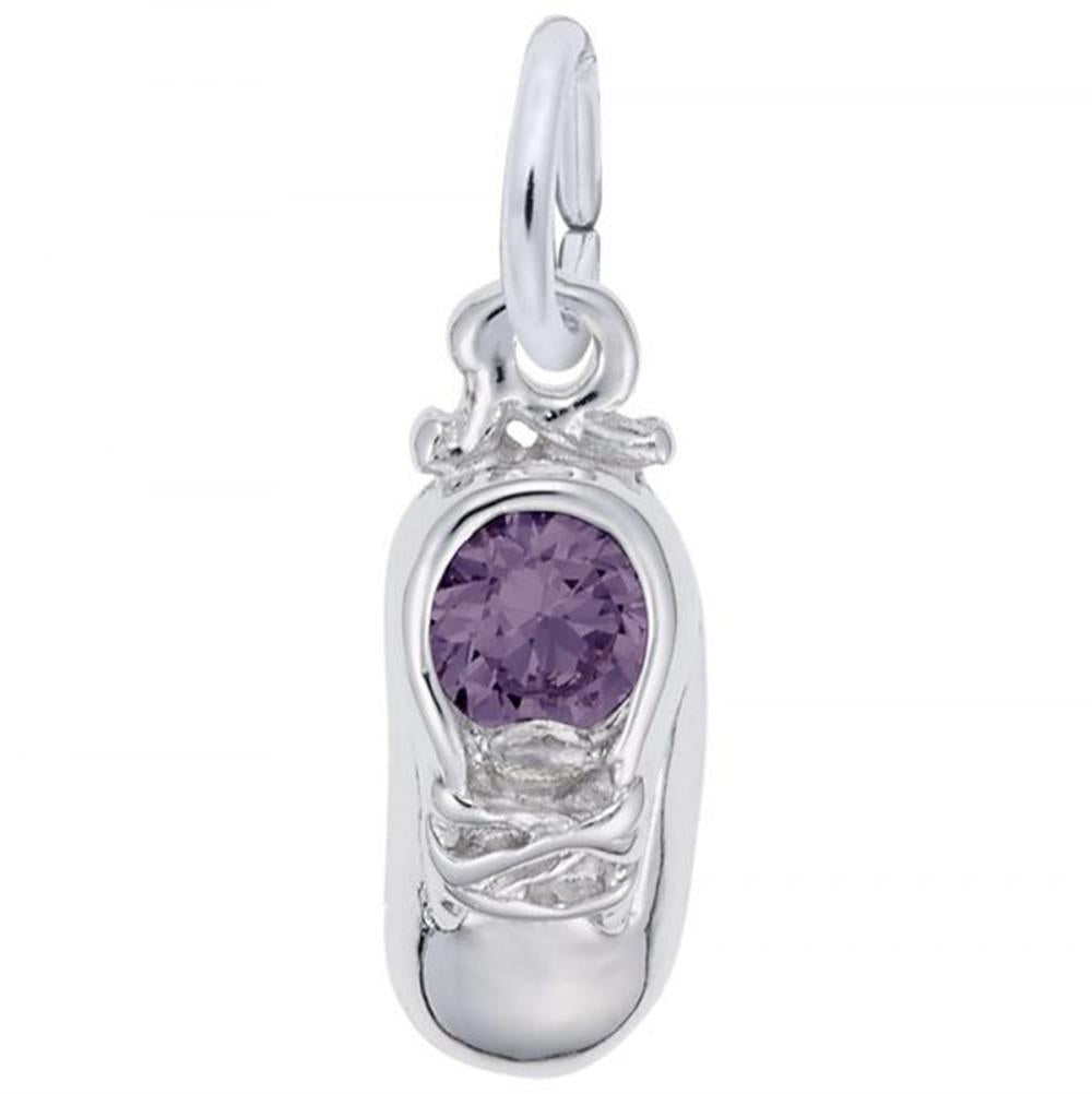 The June Baby Shoe Charm by Rembrandt Charms is crafted from sterling silver, showcasing detailed laces and a round purple gemstone at its center. It includes a loop for effortless attachment to bracelets or necklaces and is presented against a plain white background.