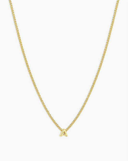 The Gorjana Wilder Mini Alphabet Necklace - A is an 18k gold plated piece featuring a small, gold capital "A" pendant centered on a plain white background—an ideal personalized jewelry accessory.
