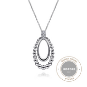 The Gabriel & Co 925 Sterling Silver White Sapphire Pendant Necklace (Serial No: S17) features a beautiful pendant from the Bujukan Collection. This elegant piece boasts an outer loop of small metallic beads encircling a smooth, oval inner loop. The pendant is suspended from a fine chain, and proudly displayed beside it is the "Design Award Instore 2021 Winner" badge.