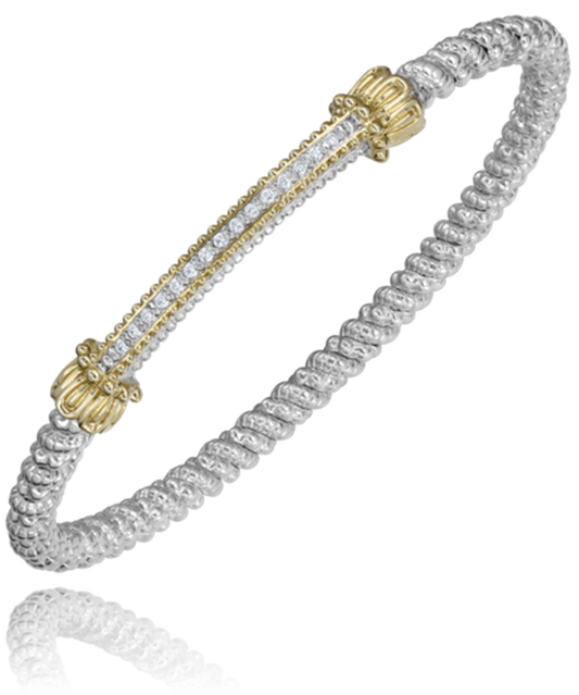 The intricately designed Alwand Vahan Jewelry sterling silver bracelet features twisted metalwork and decorative 14k gold accents at the clasp points, adorned with a central row of sparkling diamonds weighing 0.11 carats. The bracelet’s sleek, reflective surface adds elegance to its luxurious appearance. The band is 3mm wide, complementing the overall sophisticated design.