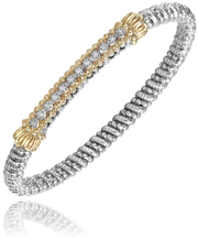 The Alwand Vahan Jewelry 4mm Closed Band Bracelet in sterling silver showcases intricate 14K yellow gold accents and 0.10CT diamond embellishments on the top section. The gold accents feature two rows of small white gems set in a decorative pattern, complementing the bracelet's flexible and elegant design.