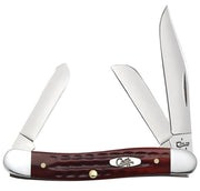 The Pocket Worn Old Red Bone Corn Cob Jig Medium Stockman by W.R. Case & Sons Cutlery Co. features three open stainless steel blades of different shapes and sizes for varied uses. It has a dark brown, textured handle with silver bolsters and a metal emblem displaying the word 'Case.'