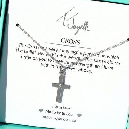 The T Jazelle Cross CZ Sterling Silver Charm Necklace features a cross charm on an adjustable sterling silver chain, presented in a turquoise box with a card explaining its meaning and the phrase "Made With Love.