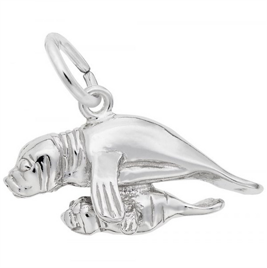 The Rembrandt Charms Manatee with Calf Charm is crafted from polished sterling silver, featuring a loop on the top for easy attachment to any chain. The charm beautifully depicts a streamlined manatee swimming gracefully with its calf, showcasing detailed flippers and facial features. This exquisite piece makes a charming addition to any jewelry collection.