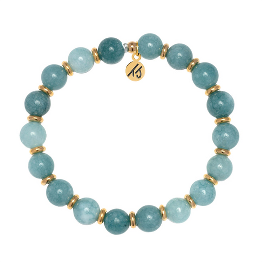 Part of the T Jazelle Gold Empowered Elegance Collection, the Mountain Blue Jade Gemstone Bracelet features round blue-green stones, gold spacers, and an engraved gold charm arranged in a circle on a white background.