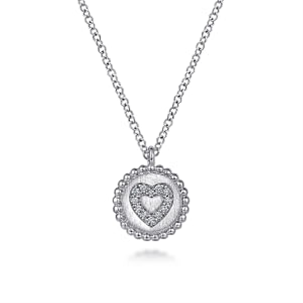 Introducing the Gabriel & Co 925 Sterling Silver Bujukan Diamond Heart Pendant Necklace, a delicate piece featuring a circular pendant with a raised heart design at its center, encrusted with sparkling small diamonds. This stunning necklace also boasts a border of evenly spaced beads, adding texture to the overall design from the Bujukan Collection.