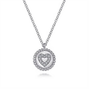 Introducing the Gabriel & Co 925 Sterling Silver Bujukan Diamond Heart Pendant Necklace, a delicate piece featuring a circular pendant with a raised heart design at its center, encrusted with sparkling small diamonds. This stunning necklace also boasts a border of evenly spaced beads, adding texture to the overall design from the Bujukan Collection.