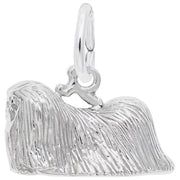 The Rembrandt Charms Pekingese Dog Charm in sterling silver features a detailed design of a long-haired Pekingese lying down, with textured fur and a small loop at the top for easy attachment to a bracelet or necklace.