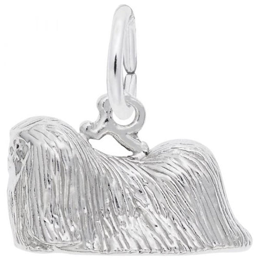 The Rembrandt Charms Pekingese Dog Charm in sterling silver features a detailed design of a long-haired Pekingese lying down, with textured fur and a small loop at the top for easy attachment to a bracelet or necklace.