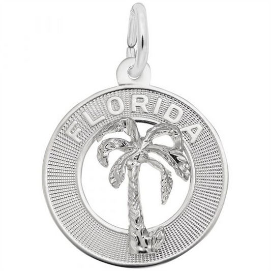 The Florida Palm Tree Ring Charm in Sterling Silver by Rembrandt Charms features the word "FLORIDA" at the top and a raised palm tree in the center. This exquisite piece has a circular border with a textured pattern and a small loop at the top for attaching to a bracelet or necklace.